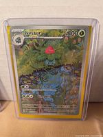 Front view of Ivysaur holographic card inside toploader
