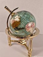 Side view showing globe orientation, brass stand and materials