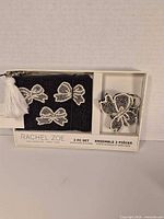 Front view of boxed Rachel Zoe 2-piece beaded coin purse and keychain set