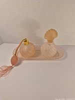 Front view of both perfume bottles on tray