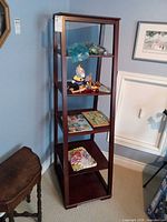 Full view of dark wood ladder shelf with five shelves