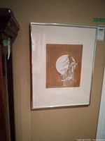 Full view of framed etching in silver frame