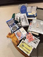 Overview of all boxed baby keepsake items on table