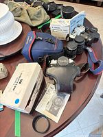 Overview of Canon FTb camera, lenses, flash box, bellows box, camera bag, manuals