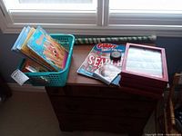 Overview of lot: books in basket, puzzle pad, puck, hockey stick, CD, frames
