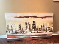 Full view of abstract cityscape canvas print leaning against wall