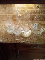 Grouped view showing all glass and crystal pieces on countertop