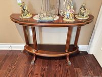Front view of console table showing full shape, finish and decorative feet