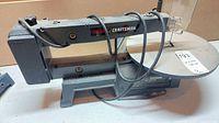 Left side profile showing overall saw, base and table