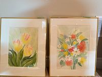 Both framed floral paintings side by side
