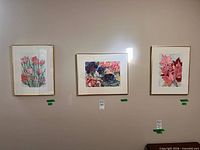 Three framed floral watercolors on wall
