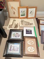 Overall view of nine artworks laid out on floor