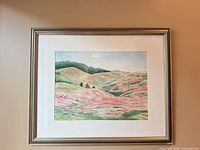 Full view of framed watercolor landscape in silver frame