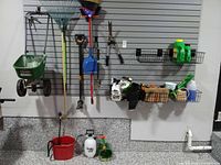 Overall view of all tools hung on slat wall and items in wire baskets
