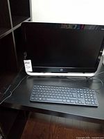 Front view of HP Pavilion 23 all-in-one with keyboard on desk