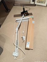 Overall view of three lamps: IKEA LEDING boxed track light, swing-arm lamp, black bar lamp