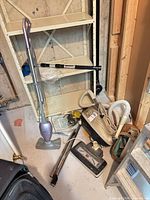 Lot overview showing Shark steam mop, Interstate vacuum canister, hose, wands, powerhead and accessories