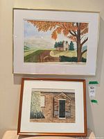 Both framed watercolors: barn scene above, doorway scene below