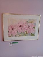 Framed watercolor floral painting on wall