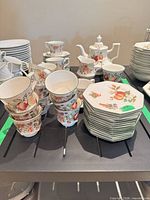 Full group showing cups stacked, saucers, creamer and teapot