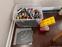 Bin of assorted LEGO bricks and baseplates