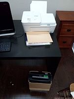 White HP DeskJet Plus 4152 printer on desk with shredder box below