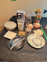 Overall view of mixed dinnerware, glassware, serveware and decorative items laid out together