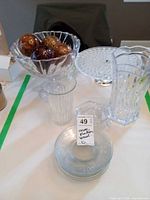 Full lot showing vase, compote with spheres, tumbler, stack of plates