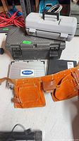 Overall lot: leather belt, three tool cases, slim case