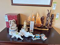 Group shot showing sailboat model, three wood sculptures, Otagiri music box, ceramic figurines, Roma magnets