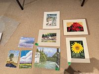All eight artworks laid out on floor