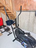 Full view of OrbiTrek elliptical cross trainer in basement setting