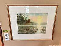 Framed watercolor landscape painting on wall