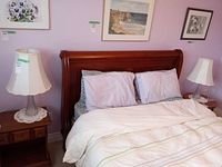 Both lamps on bedside tables flanking bed