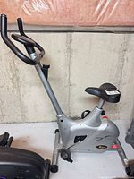 Full view of the exercise bike showing frame, seat, console area and pedals