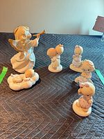 Group shot showing all five Precious Moments figurines