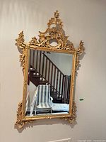 Full view of ornate gold gilt mirror on wall