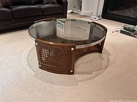 Full view of coffee table showing glass top and cane panels