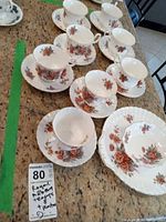 Eight teacups and eight saucers displayed on countertop showing pattern and quantity