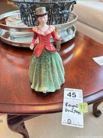 Front view of Royal Doulton Holly figurine with lot tag