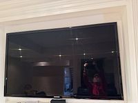 Front view of Samsung TV powered off, wall-mounted