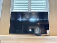 Front view of Samsung 58" TV mounted on wall