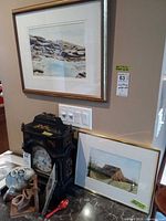 Both framed watercolors displayed together against wall