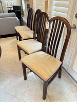 Four of the six matching chairs lined up showing overall design, upholstery and finish