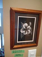 Framed scratchboard floral artwork on wall
