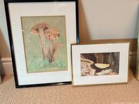 Both framed artworks side by side for scale and framing detail
