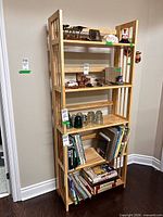 Front view of solid wood bookcase showing five shelves and slatted sides
