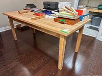 Overall view of solid wood table with items on top