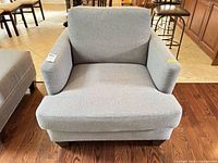 Front view of light gray woven-fabric armchair