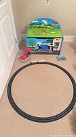 Overall view of storage chest, assembled oval track, locomotive and accessory building